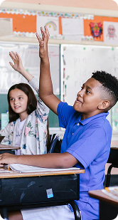 students raising hand in class